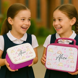 May include: Two girls holding personalized lunchboxes. One is a rectangular purple container with a white lid, the other is a pink handled bag. Both have a princess theme with crowns, carriages, and the name "Alice".