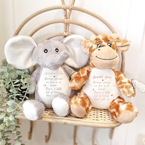 May include: Two plush stuffed animals, a gray elephant and a brown giraffe, with embroidered messages. The elephant says "Grandma Julie Because someone we love is in heaven There's a little bit of heaven here with us." The giraffe says "Grandad Gary Because someone we love is in heaven There's a little bit of heaven here with us."