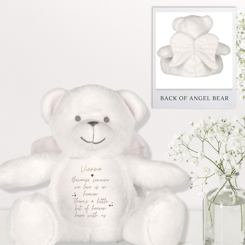 May include: White plush angel bear with pink wings. The bear has a message on its chest that reads "Vienna Because someone we love is in heaven There's a little bit of heaven here with us".