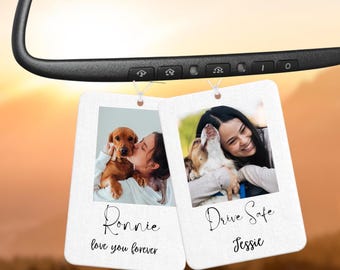 May include: Two white photo car air fresheners with a photo of a person and their dog on each. The left one says "Ronnie love you forever" and the right one says "Drive Safe Jessie".