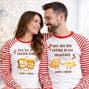 May include: Matching white pajamas with red striped sleeves. One shirt reads "You're My Butter Half" with cartoon toast and butter. The other says "You are the Butter to my Croissant" with a croissant and butter. Both shirts have the names "Lizzie & Stevie".