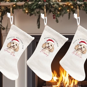 May include: Three off-white Christmas stockings hanging from a garland. Each stocking features a watercolor illustration of a dog wearing a Santa hat. Text includes "Special Delivery For Grace Rose", "Merry Christmas Mummy", and "Have a Magical Christmas Ivy Willow".