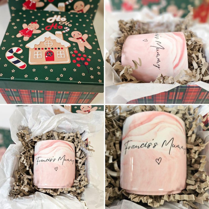 May include: A pink marble mug with the text "Francis's Mummy" and a heart. The mug is in a white gift box with brown shredded paper.