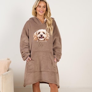 May include: A brown fleece hooded blanket with a pocket. The blanket features a printed image of a dog with the name "Lily" written below it.