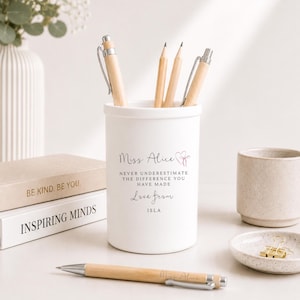 May include: A white cylindrical pen holder featuring the printed text Miss Alice, a heart icon, and the phrase Never underestimate the difference you have made, Love from ISLA. The holder contains wooden pencils and pens, with a matching pen in front.
