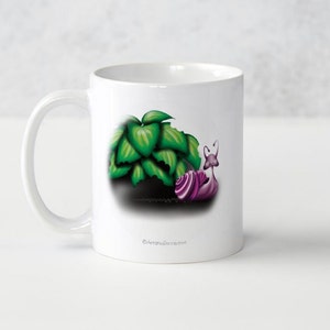 May include: White ceramic mug featuring a printed design of a purple snail and green leaves. The snail is facing right and the leaves are behind it. The mug has a white handle.