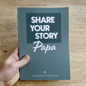 May include: A dark green journal with the text "Share Your Story Papa" in white. The journal is titled "A Grandfather's Guided Journal".