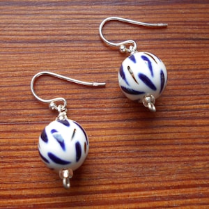 Pretty porcelain sphere earrings, blue underglaze and copper lustre strokes, smart