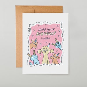 May include: A pink birthday card with a cartoon illustration of a poodle and other dogs wearing party hats. The text on the card reads "Hope your birthday is bitchin'"