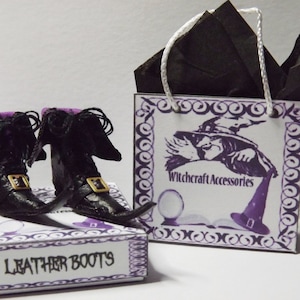 May include: A pair of black leather boots with purple trim and pointed toes, packaged in a small box with the words "Leather Boots" printed on the front. The box is sitting next to a small gift bag with a witch and the words "Witchcraft Accessories" printed on the front.