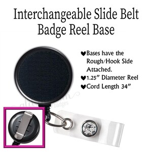 May include: Black badge reel base with a 1.25-inch diameter reel and a 34-inch cord. The base has a rough/hook side attached. The image also shows a clear badge holder with a rhinestone accent and a metal clip.