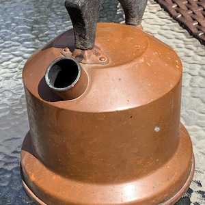 May include: A white ceramic mug with a black handle and the text "But First, Coffee" in a handwritten style. The mug is on a white surface. The mug is approximately 4 inches tall.