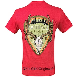 Puede incluir: Camiseta roja con un gráfico verde, amarillo y naranja de una calavera de ciervo con cuernos y el texto "Southern Limit 2016". El texto "Girlie Girl Originals" está impreso en la parte inferior de la camiseta.