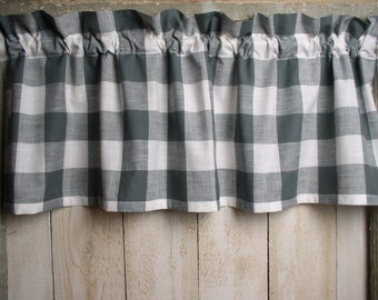 May include: A gray and white checkered valance with a ruffled top edge. The valance is made of a lightweight fabric and is perfect for adding a touch of farmhouse style to any window.