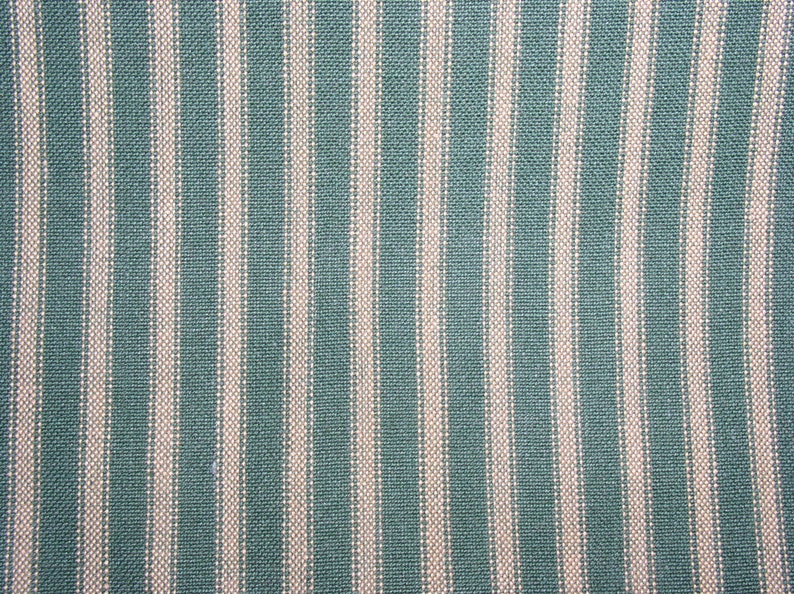 May include: A close-up of a teal and white striped fabric. The fabric has a woven texture and a subtle sheen.