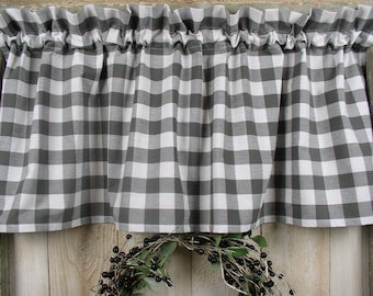 May include: A black and white gingham valance with a ruffled top edge. The valance is made of a soft, cotton fabric and is perfect for adding a touch of farmhouse style to any window.