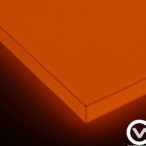 May include: A close-up of a bright orange, rectangular object with a sharp corner. The object is illuminated, creating a gradient of light and shadow. The bottom right corner features the Carbonwaves logo.