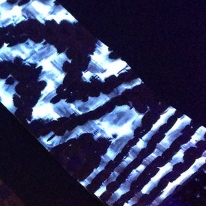 May include: A close-up of a white and black patterned fabric with a textured surface.