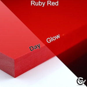 May include: A close-up of a red plastic sheet, showing the color in both daylight and under a black light. The text "Ruby Red" is at the top of the image. The text "Day" is on the left side of the image and the text "Glow" is on the right side of the image.