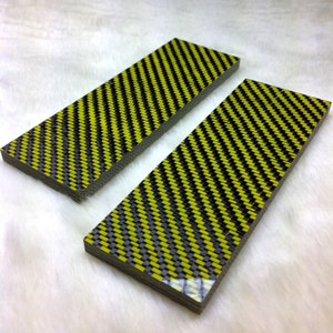 May include: Two yellow and black carbon fiber scales for knife making. The scales are rectangular and have a woven pattern.