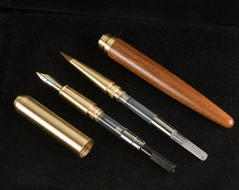 May include: Three fountain pens, one with a wooden barrel and two with brass barrels. The pens are disassembled, showing the inner workings of the pens.
