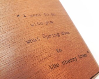 May include: A wooden plaque with the text "I want to do with you what spring does to the cherry trees."