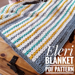 May include: A crochet blanket with stripes of gray, white, yellow, and teal. The blanket is on a wooden surface and has the text "Eleri Blanket PDF Pattern" on it.