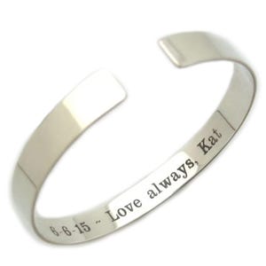 May include: Silver bangle bracelet engraved with the message "6-6-15 - Love always, Kat".