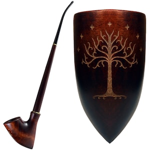 May include: A wooden pipe with a long, curved stem and a bowl shaped like a shield. The shield has a carved design of a tree with stars around it.