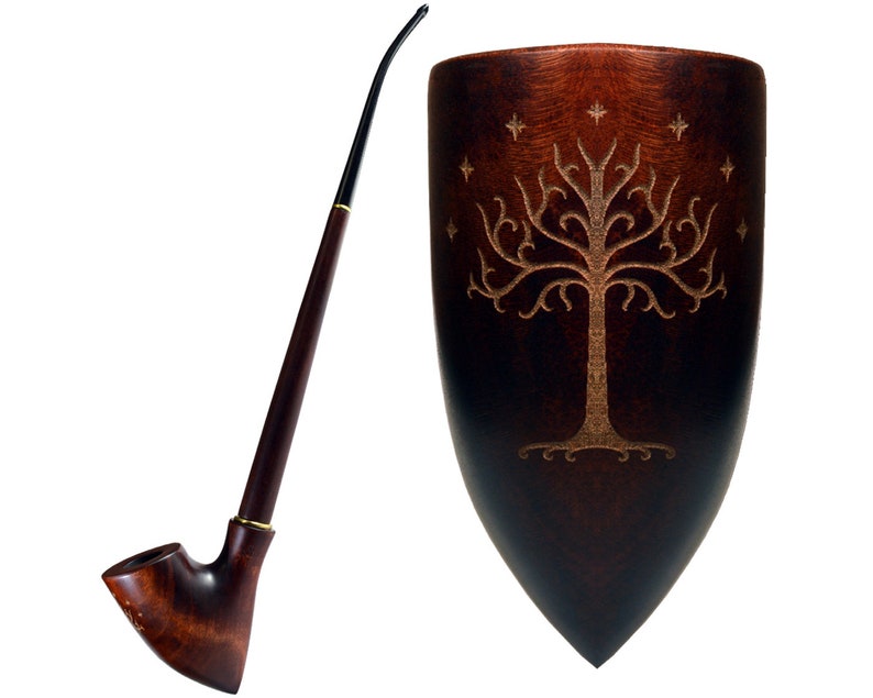 May include: A wooden pipe with a long, curved stem and a bowl shaped like a shield. The shield has a carved design of a tree with stars around it.