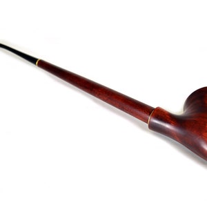 May include: A long, dark brown wooden pipe with a black mouthpiece and a curved bowl.