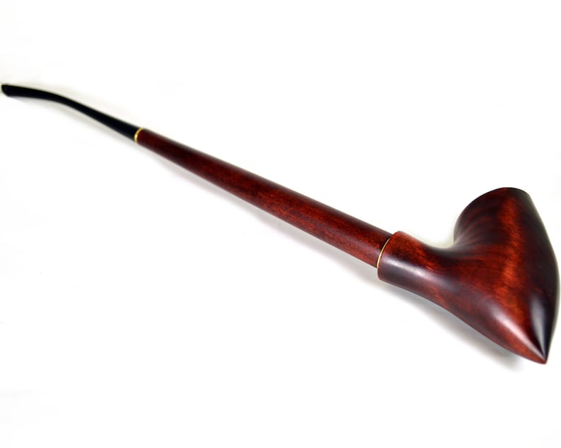May include: A long, dark brown wooden pipe with a black mouthpiece and a curved bowl.
