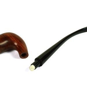 May include: A brown wooden pipe with a black stem and a white mouthpiece. The pipe is disassembled, showing the bowl and stem separately.