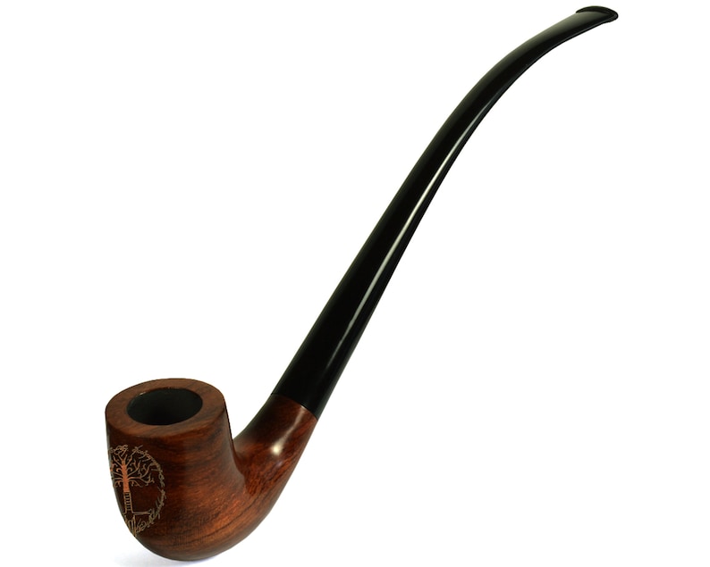 May include: A brown wooden smoking pipe with a black stem and a tree of life design on the bowl.