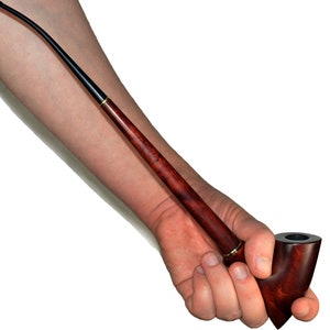 May include: A long, thin, wooden smoking pipe with a curved bowl and a black stem. The pipe is held in a hand.