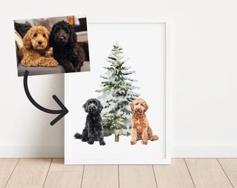 May include: A framed print featuring a watercolor illustration of a snow-covered Christmas tree with two dogs. One dog is black, and the other is a golden color. The print also includes a photo of two dogs, one golden and one black, sitting on a gray couch.