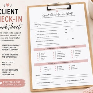 May include: A client check-in worksheet on a wooden clipboard with a metal clip. The worksheet has pink and black text, with sections for mood, energy, and emotions. A white pen and a mug that says "be kind to your mind" are also visible.
