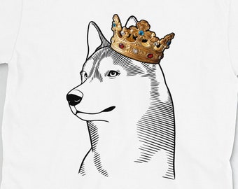 May include: White t-shirt with a black and white illustration of a husky dog wearing a gold crown with jewels.