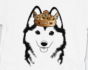 May include: White t-shirt with a black and white illustration of a husky dog wearing a gold crown with colorful jewels.
