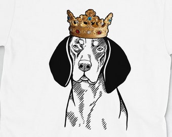 May include: White t-shirt featuring a black and white illustration of a dog wearing a gold crown. The dog has a black nose and brown eyes.
