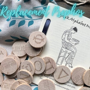 May include: Wooden tokens with Greek letters and a decorative border, in a white drawstring bag. The tokens are part of a Greek Alphabet Oracle set. The text on the card reads "Greek Alphabet Oracle".