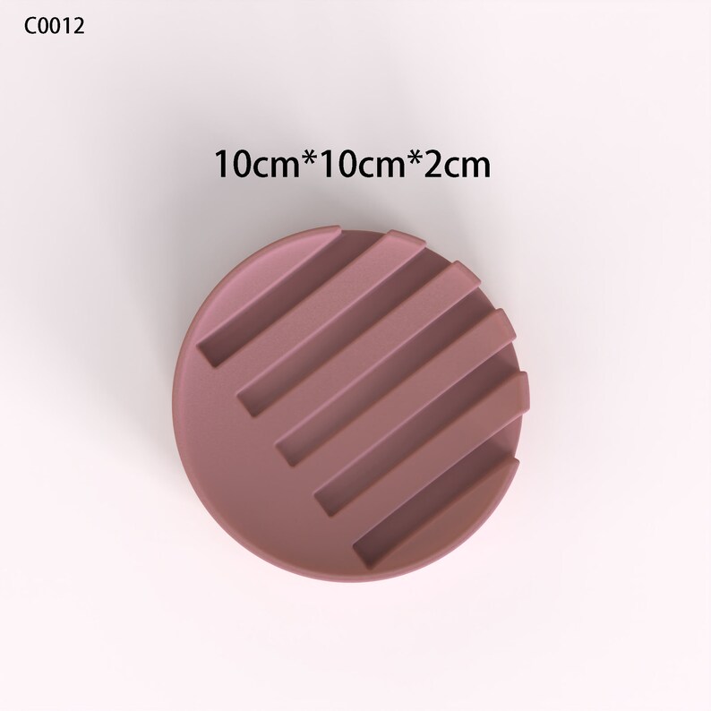 May include: A round, mauve-colored silicone soap dish with five raised ridges. The dish measures 10 inches by 10 inches by 2 inches.