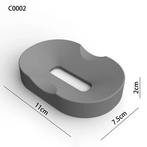 May include: Gray, oval-shaped cushion with a rectangular cutout in the center. The cushion measures 11 inches long, 7.5 inches wide, and 2 inches high.