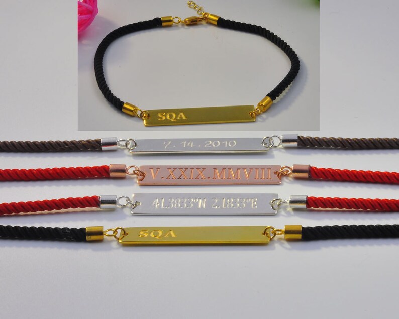 May include: Four personalized bracelets with different colored cords and engraved metal plates. The plates have the text "SQA", "7.IV.2010", "V.XXXIX.MMVIII", and "41.3837&deg;N 2.1833&deg;E".