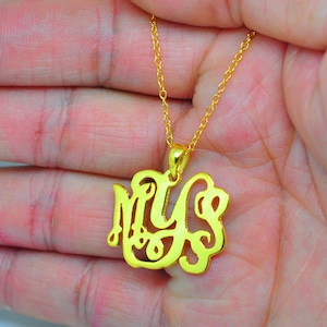 May include: A gold-tone necklace with a pendant featuring the letters "MY" in a cursive script.