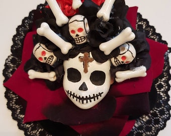 Day of the dead red voodoo doll in big velvet rose, skulls and bones fascinator