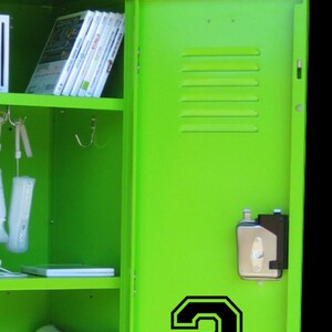 May include: A green metal locker with a white gaming console inside and a number "3" on the door.