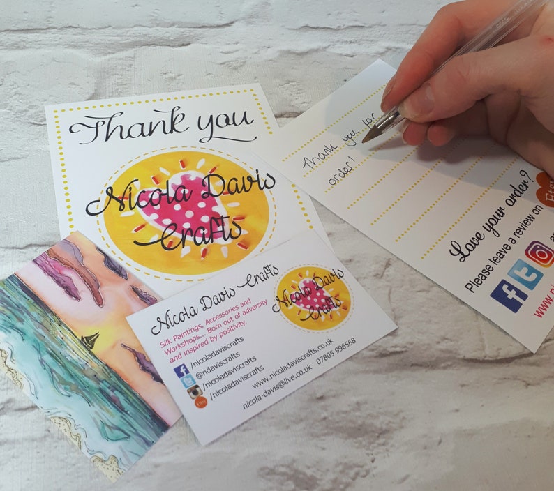 May include: A thank you card with a yellow circle and a red heart with white polka dots. The text "Nicola Davis Crafts" is written in black cursive lettering. The card also includes a business card with the same logo and contact information.