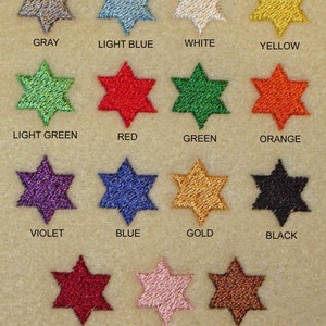 May include: A chart of thread colors for embroidery, showing 14 different colors of thread in the shape of a six-pointed star. The colors are: gray, light blue, white, yellow, light green, red, green, orange, violet, blue, gold, black, wine, pink, and harvest brown. The text "THREAD COLORS" is at the bottom of the chart.