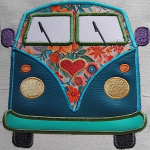 May include: Embroidered patch featuring a teal blue vintage van with a floral pattern on the front. The van has two round yellow headlights, a red heart, and purple side mirrors. The windshield wipers are black.